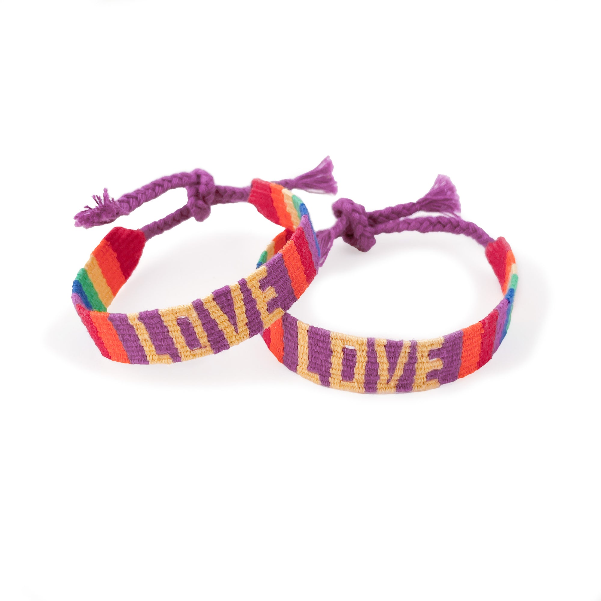 Two friendship bracelets, with the word LOVE in pale yellow over a purple background with color block rainbow stripes and purple ties