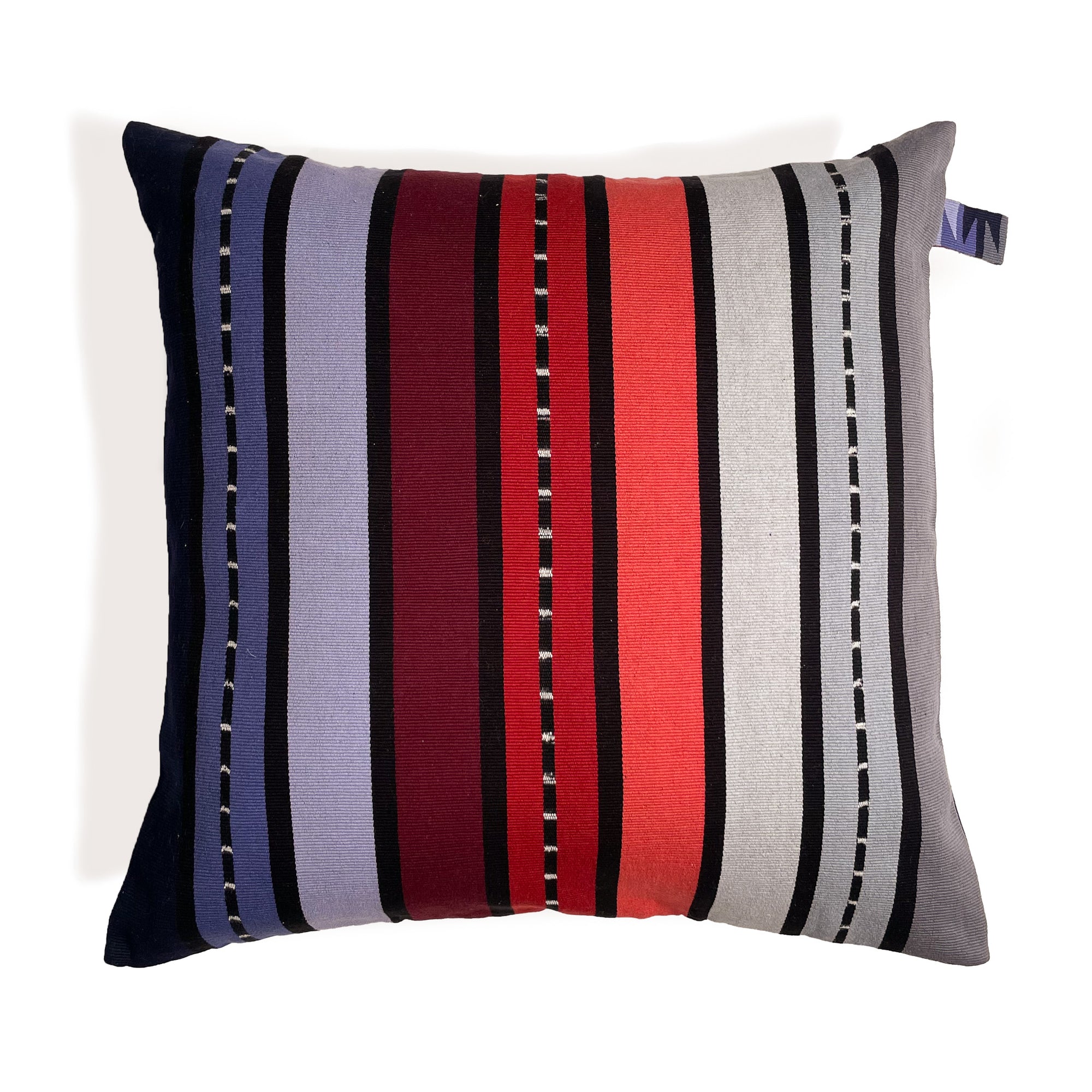 Front of cushion with colorful stripes grading from black, purple, red, to grey, with colorful cinta tag