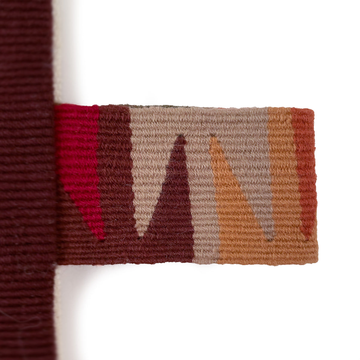 Closeup of colorful cinta tag in tones of red and brown