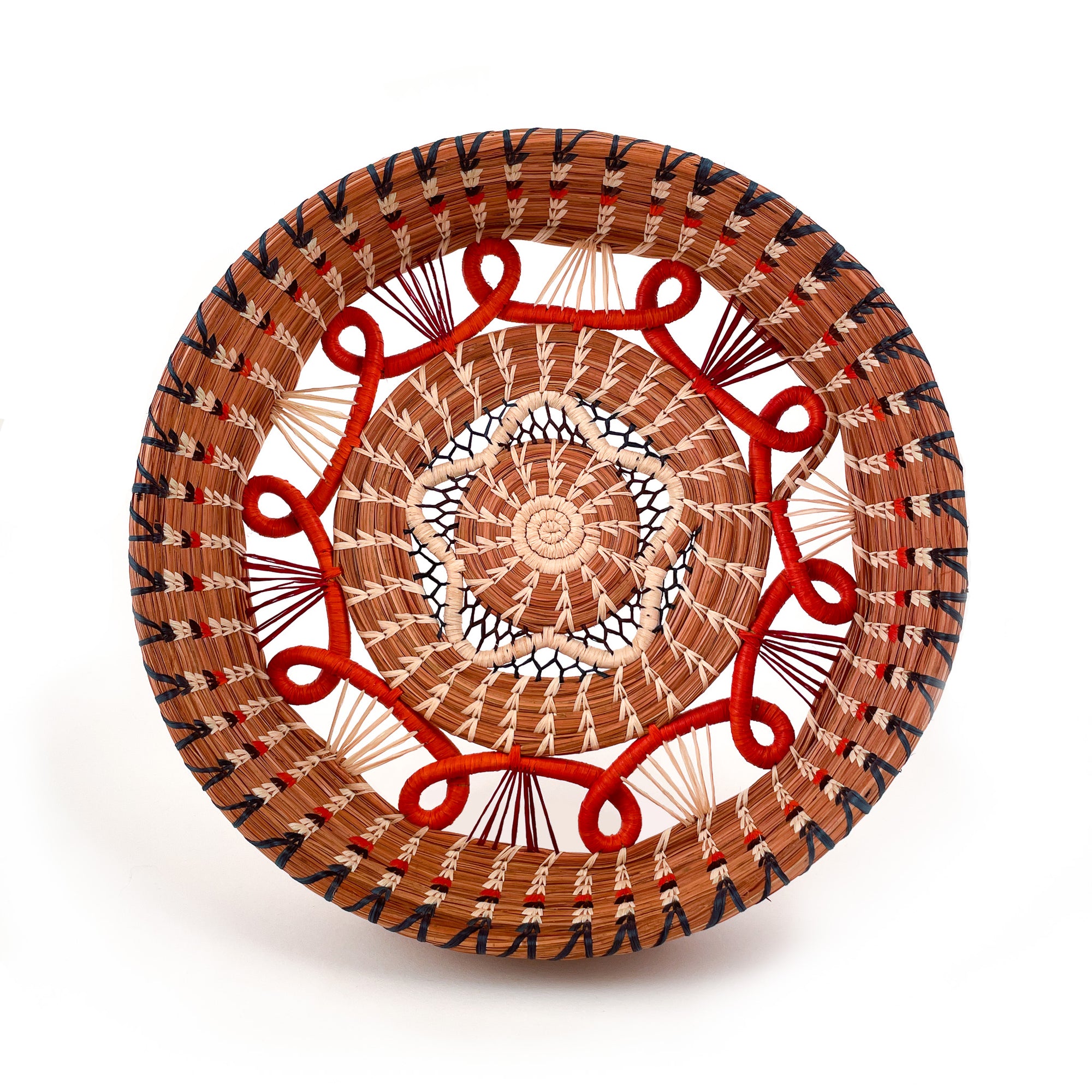 Front-facing view of Cristina Basket in Orange, a circular basket with star-shaped accent in center, surrounded by orange loop detail and intricate raffia stitching