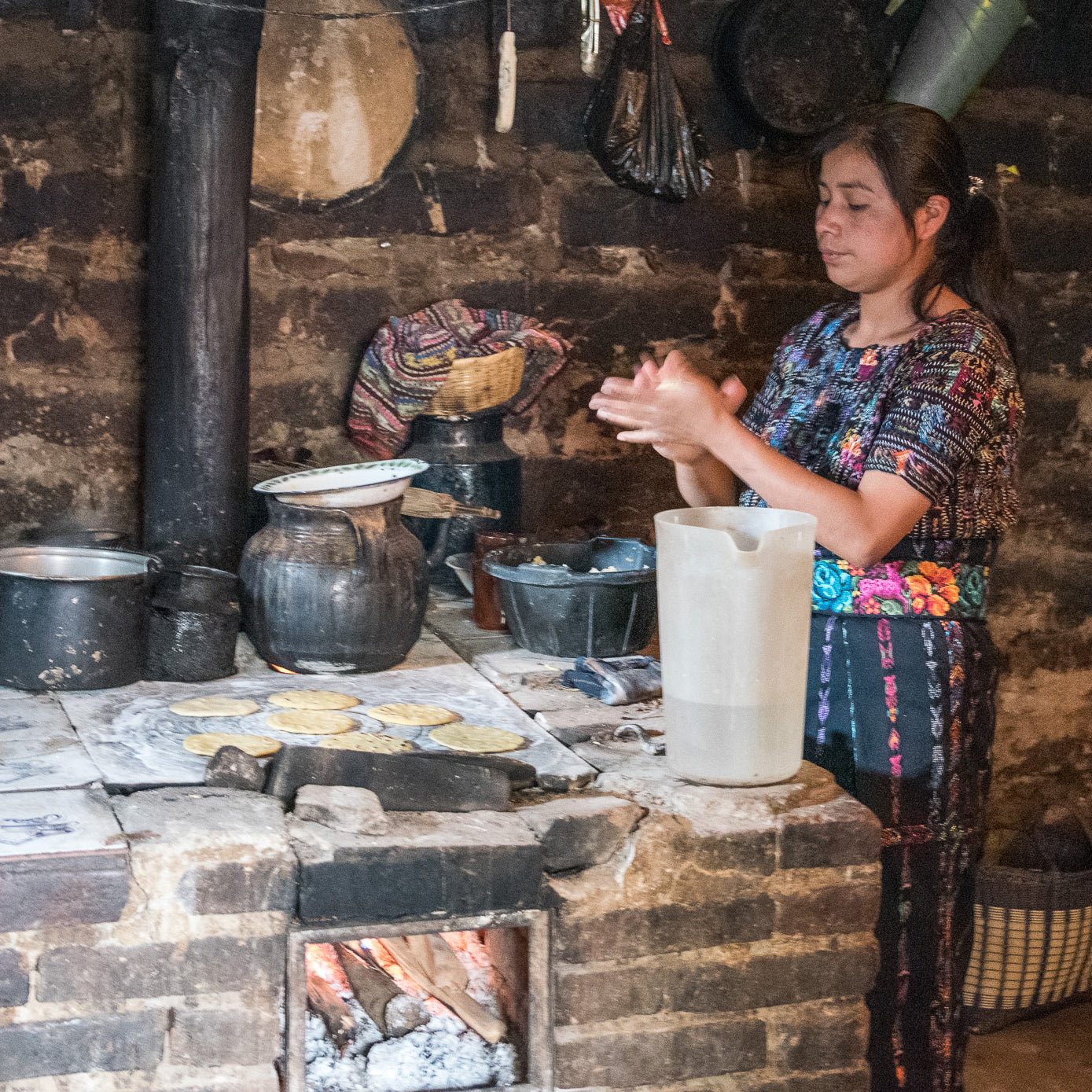 Mayan Hands weaver makes tortillas