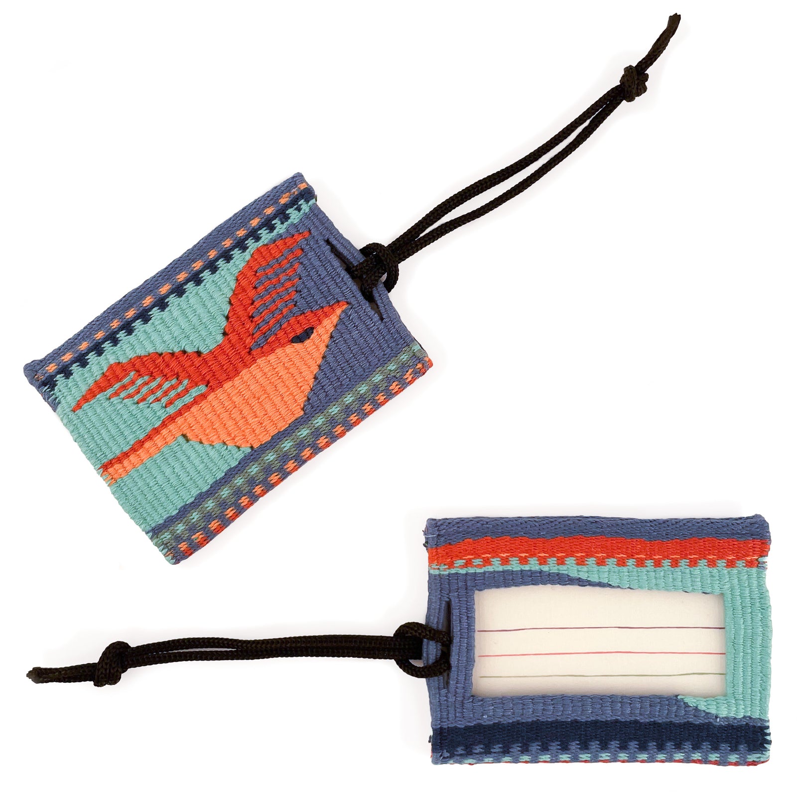 Overhead view of tapestry woven luggage tag, featuring bird motif in two shades of orange on teal and dusty blue background on front, and ID card window on back