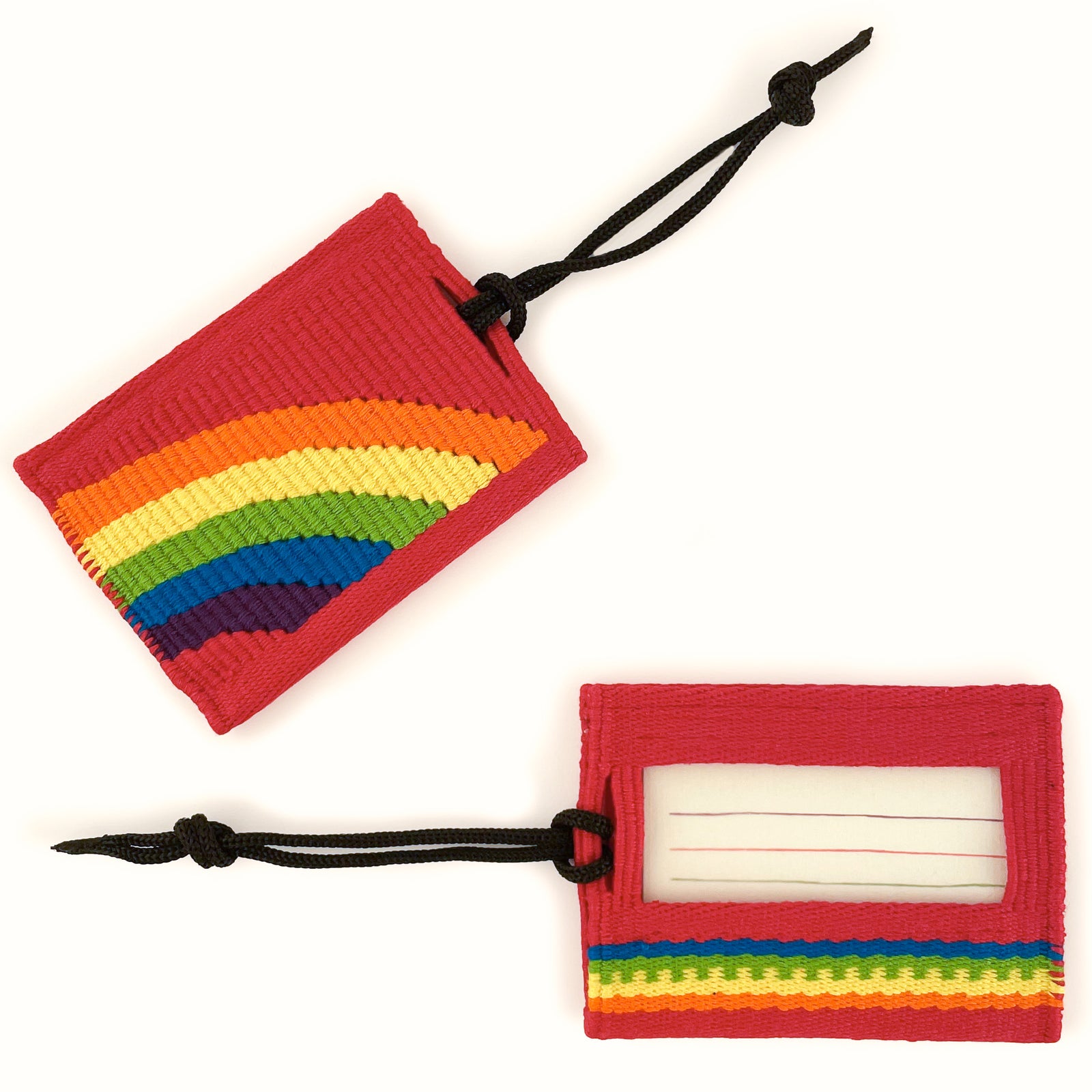 Overhead view of tapestry woven luggage tag on white background, with rainbow stripe arc on red background on front, and ID card window on back with rainbow stripe accent
