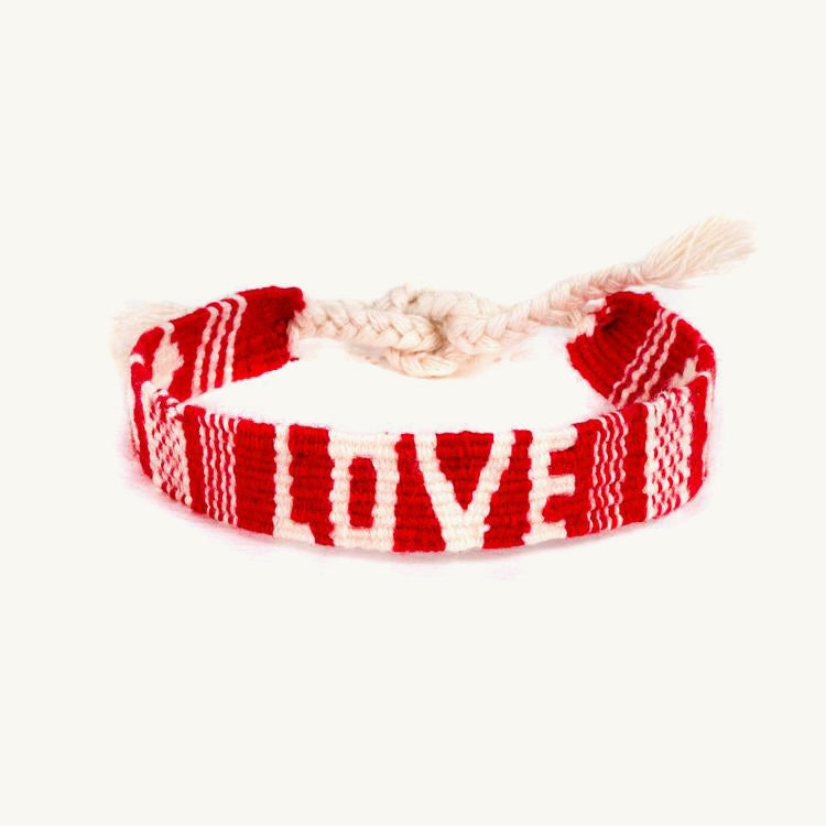 Red friendship bracelet with the word LOVE in white