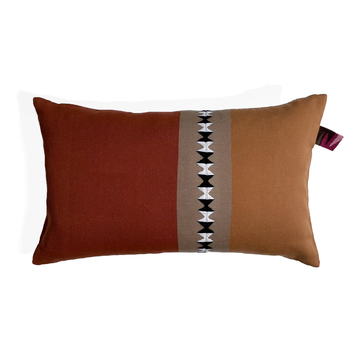 Front of rectangular cushion with color block panels in different shades of brown, with black and white randa detail on center panel, with colorful cinta tag