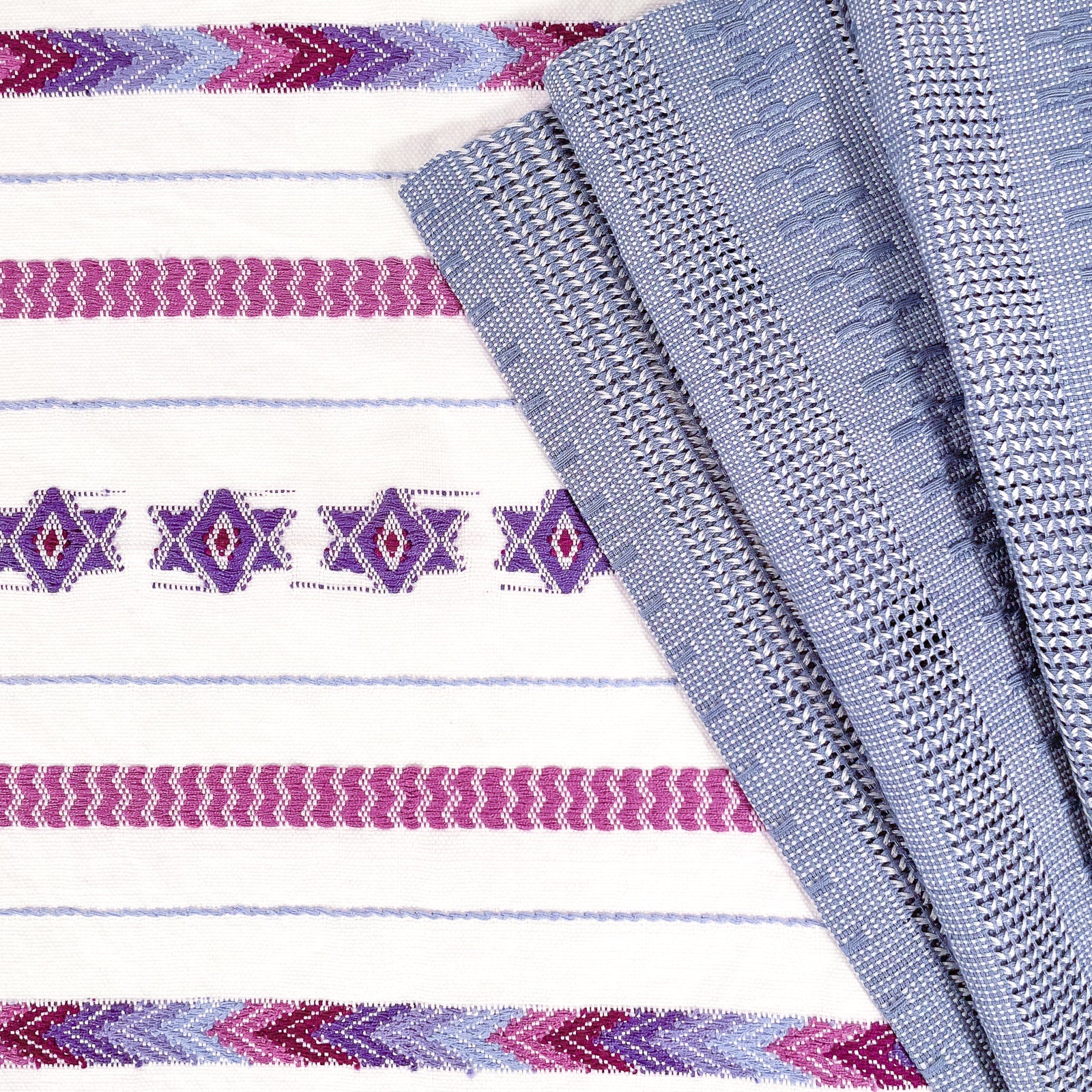 Overhead view of Brocade Challah Cover in Purple, featuring purple brocade details on a white background, with fringed edges