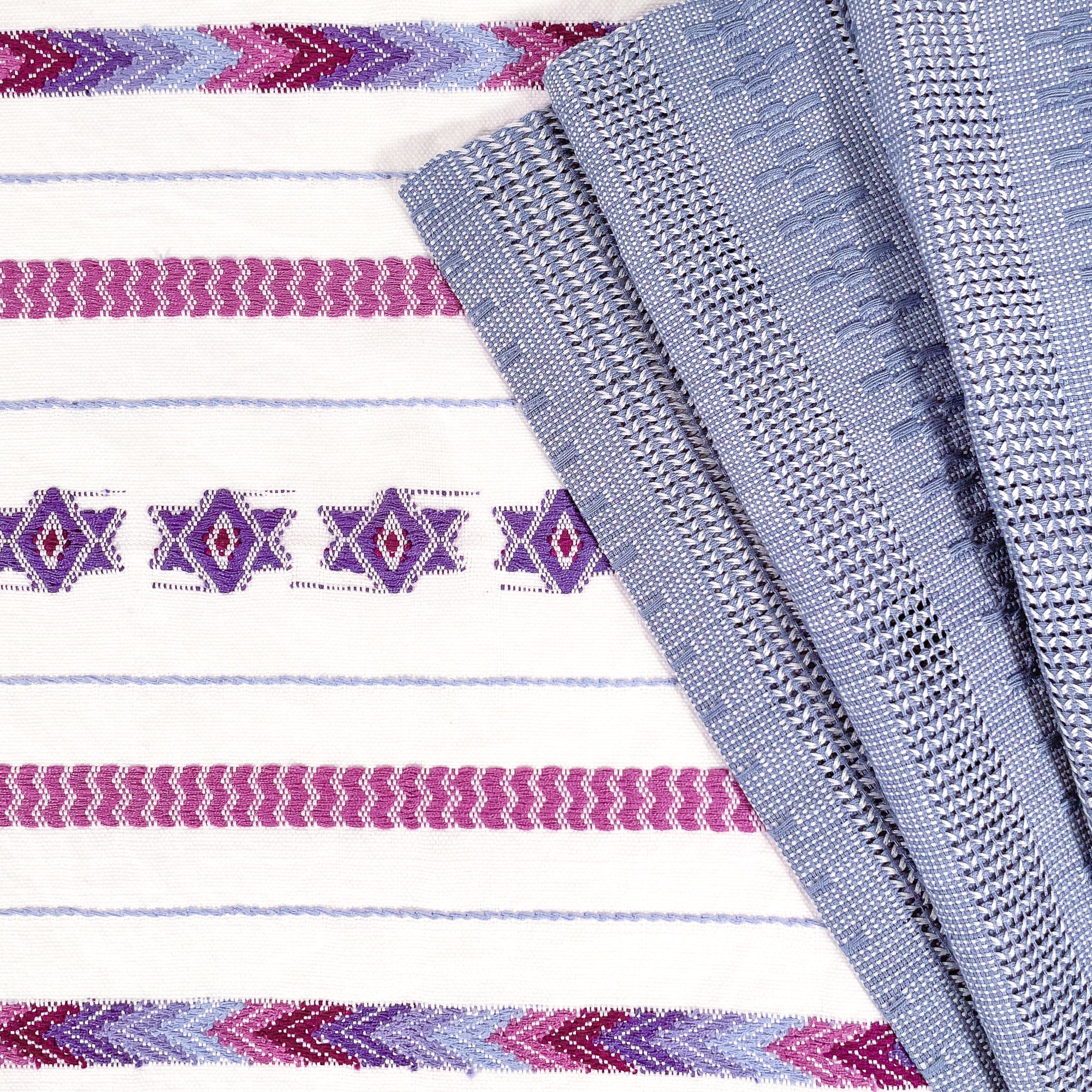 Overhead view of Brocade Challah Cover in Purple, featuring purple brocade details on a white background, with fringed edges