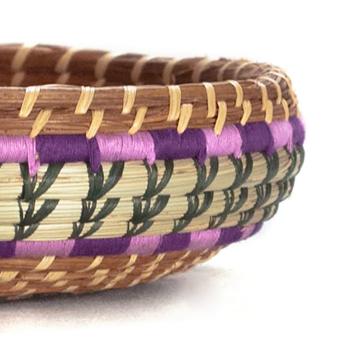 detail of pine needle basket with purple and green accents