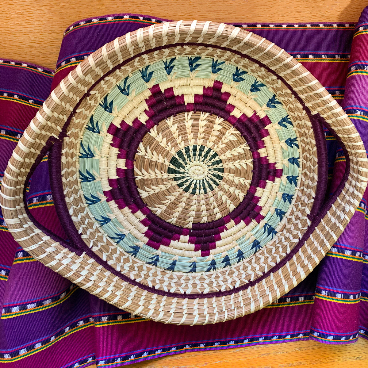 Guatemalan pine needle basket with handles in purple with table runner