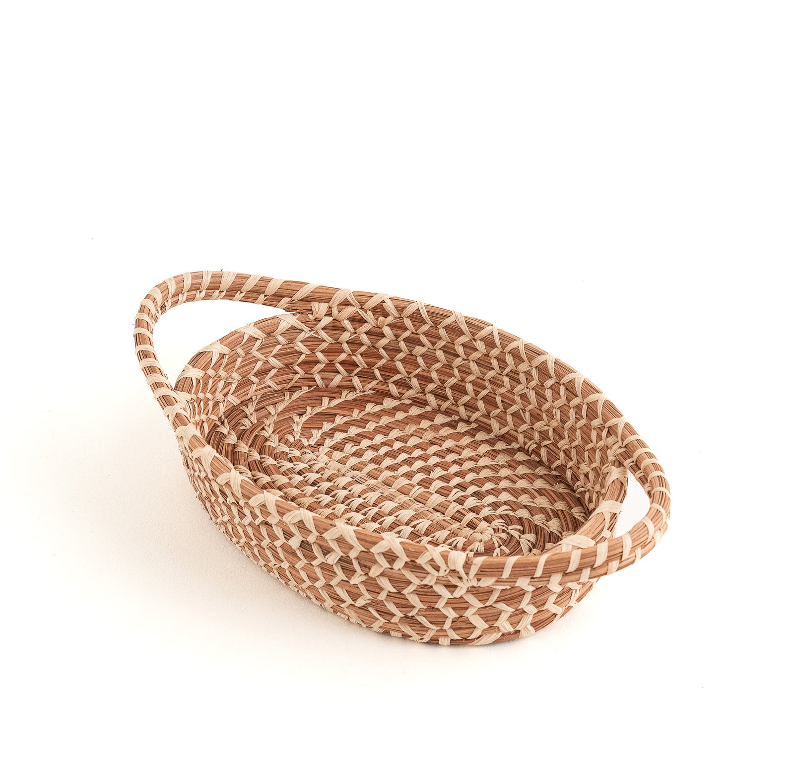 oval pine needle basket with handles, showing intricate stitches