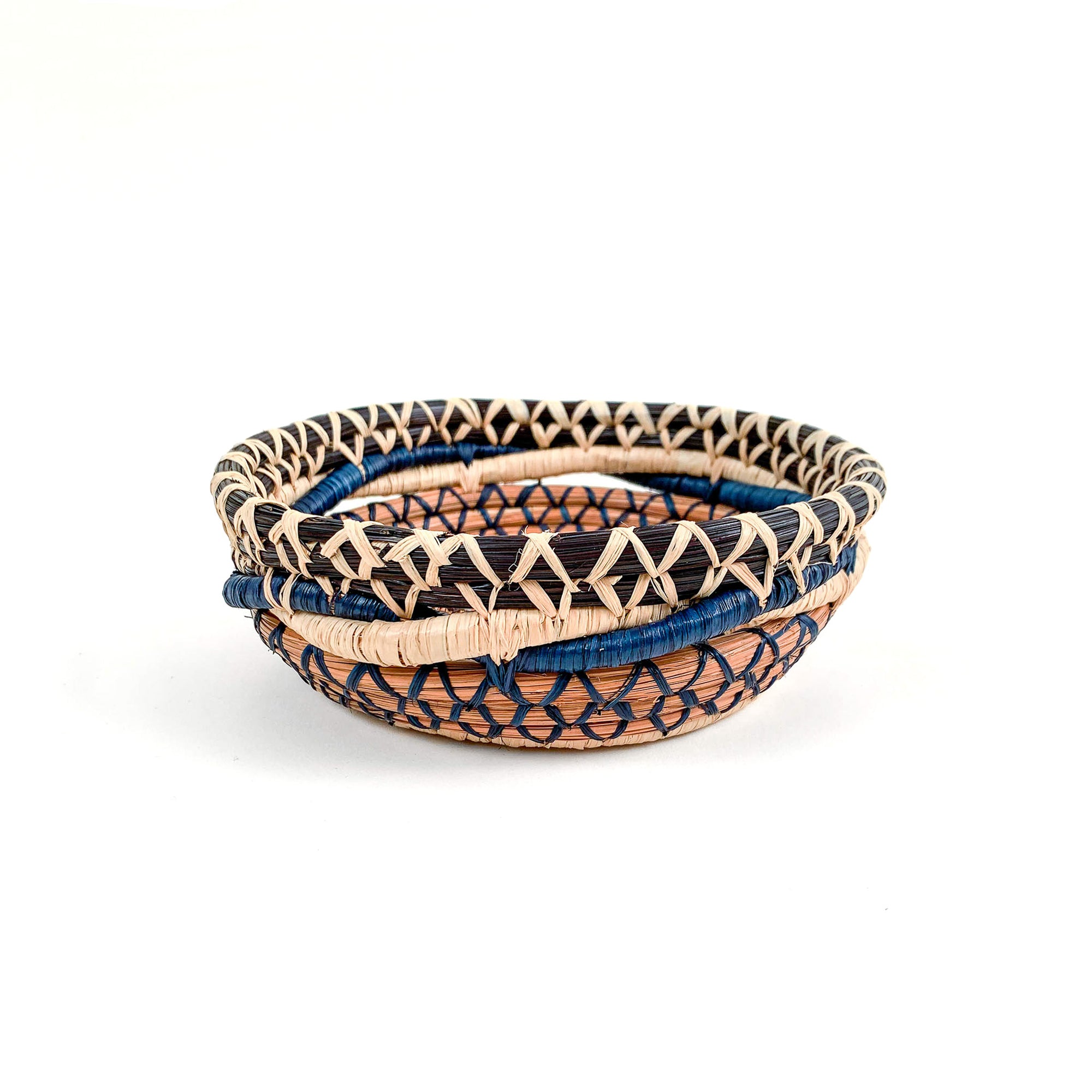 Pine needle basket with twining coils in browns and blue