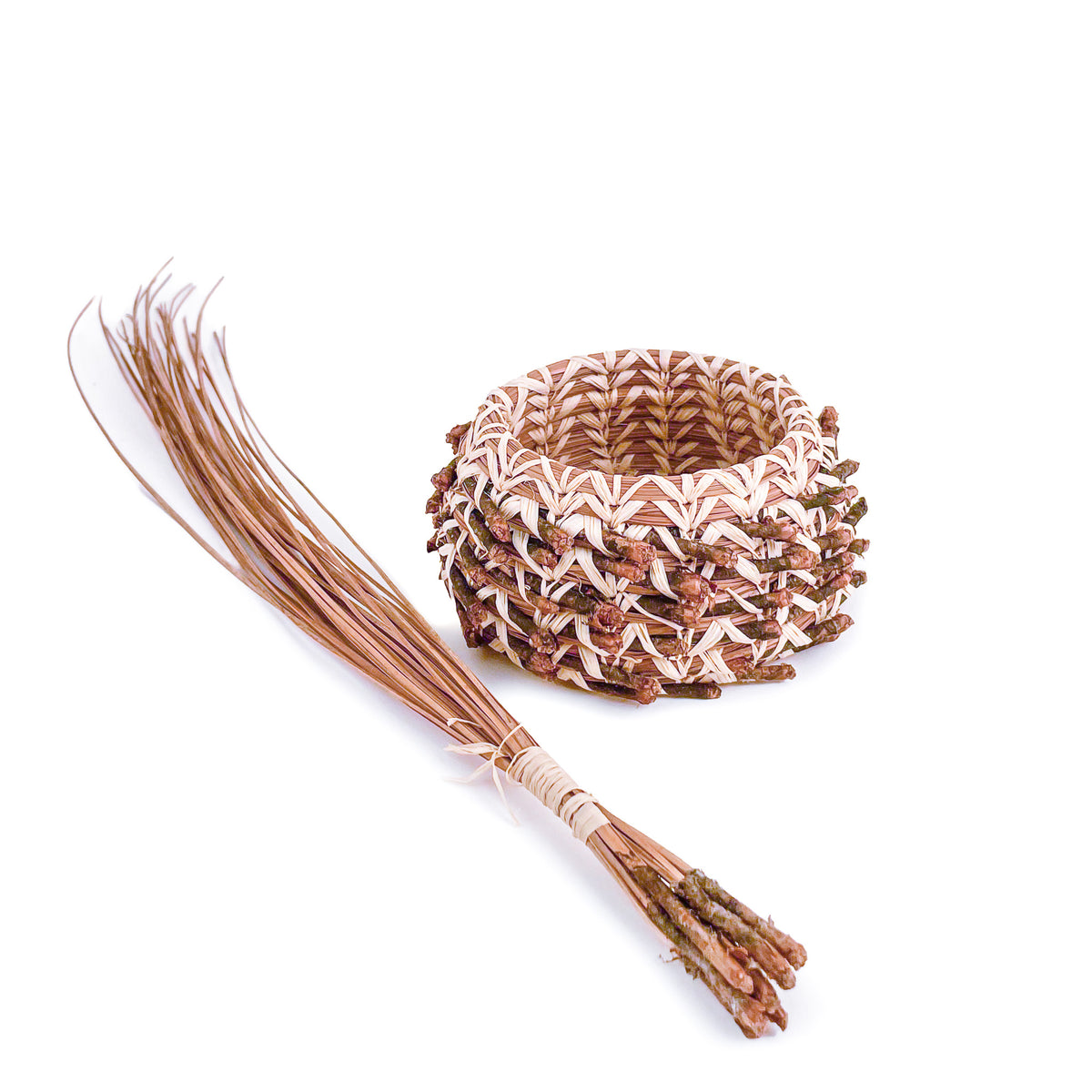 Pine Needle Points Basket next to bundle of longleaf pine needles