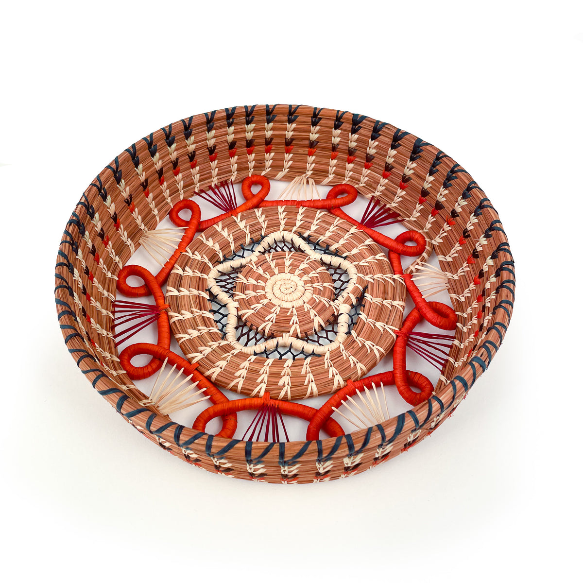 Front-facing view looking down into circular basket with star-shaped accent in center, surrounded by orange loop detail