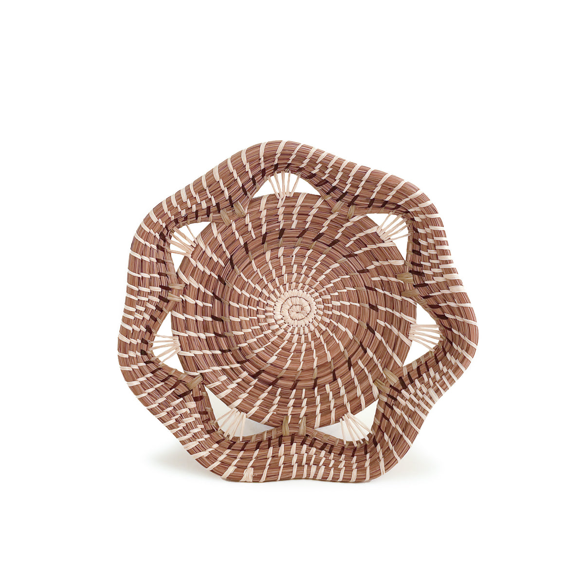 Front facing view of woven pine needle Adela Basket, with geometric rim, on white background