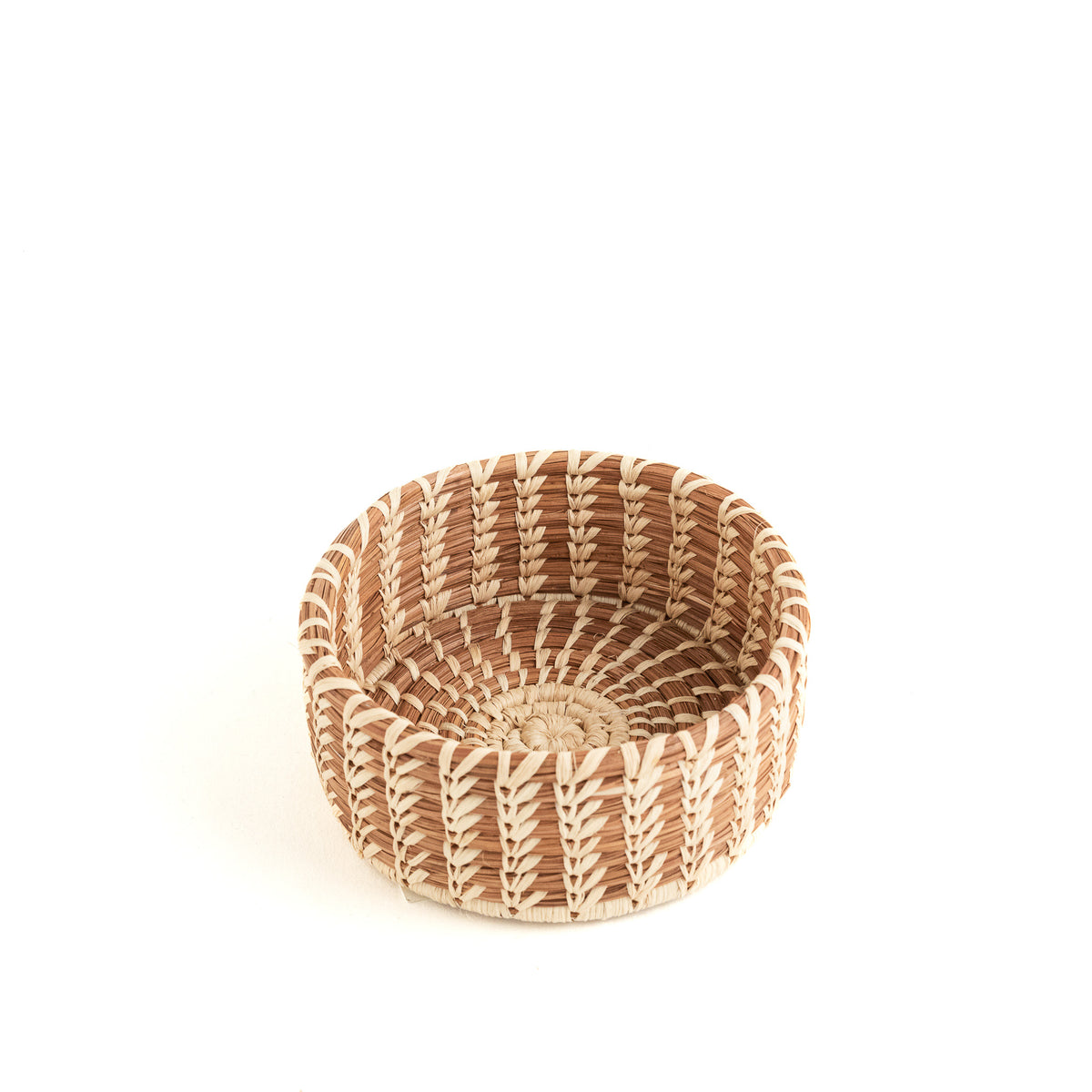 small round pine needle basket with straight sides and decorative stitching