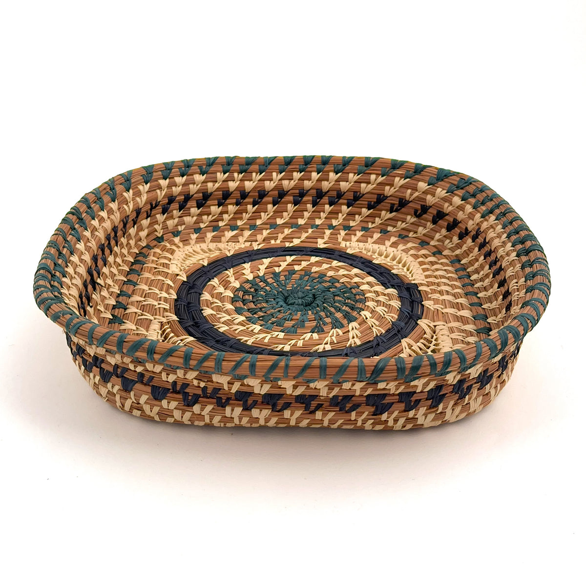 Pine needle basket with dyed raffia stitching