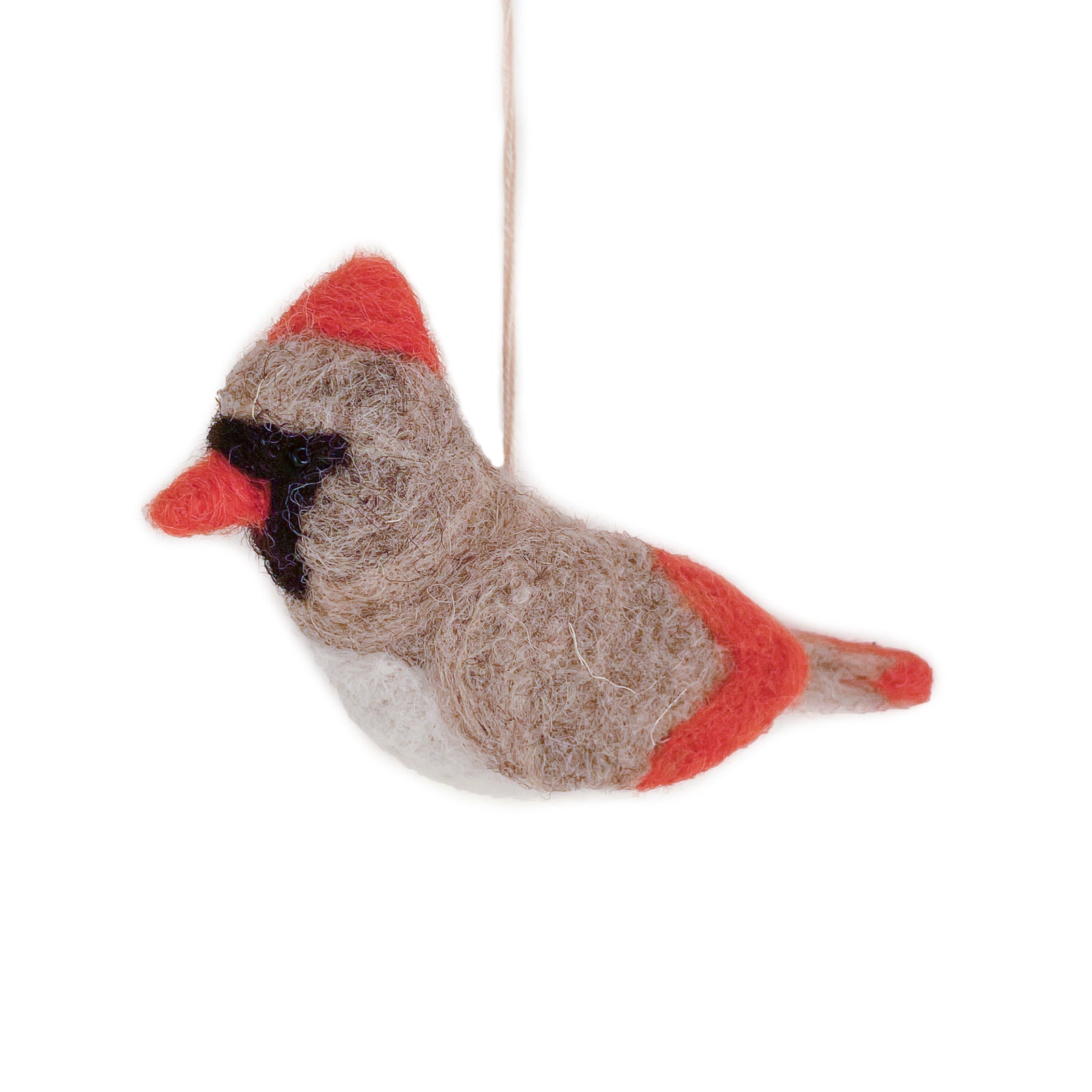 A felted wool female cardinal ornament, with beige grey body, red crest and tail, white belly, and black eye patch, hanging from a thin string against a white background.