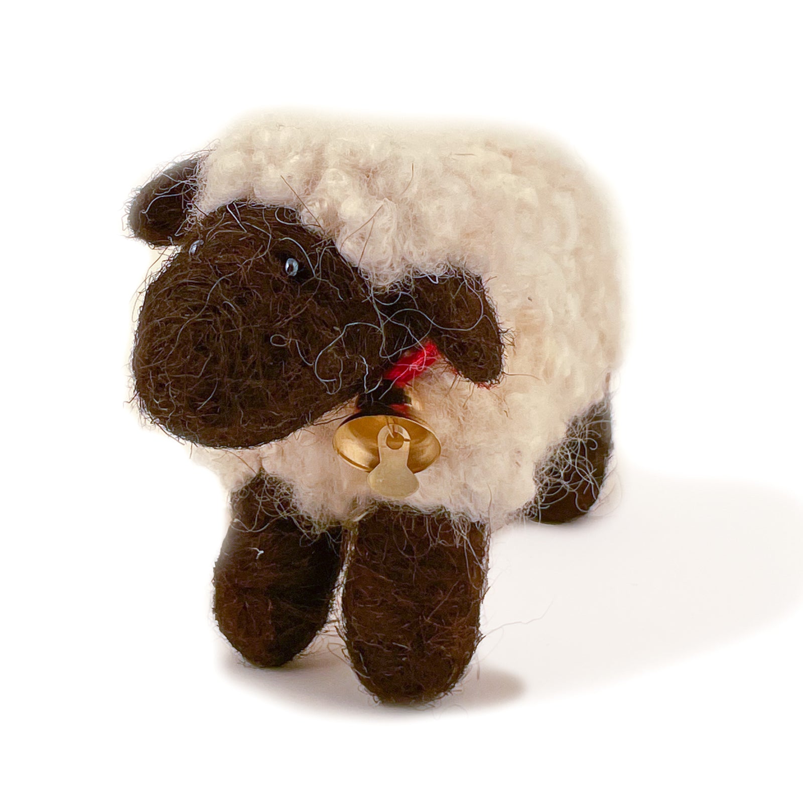 Felted wool sheep with brown wool face and feet and white wool body, with bell