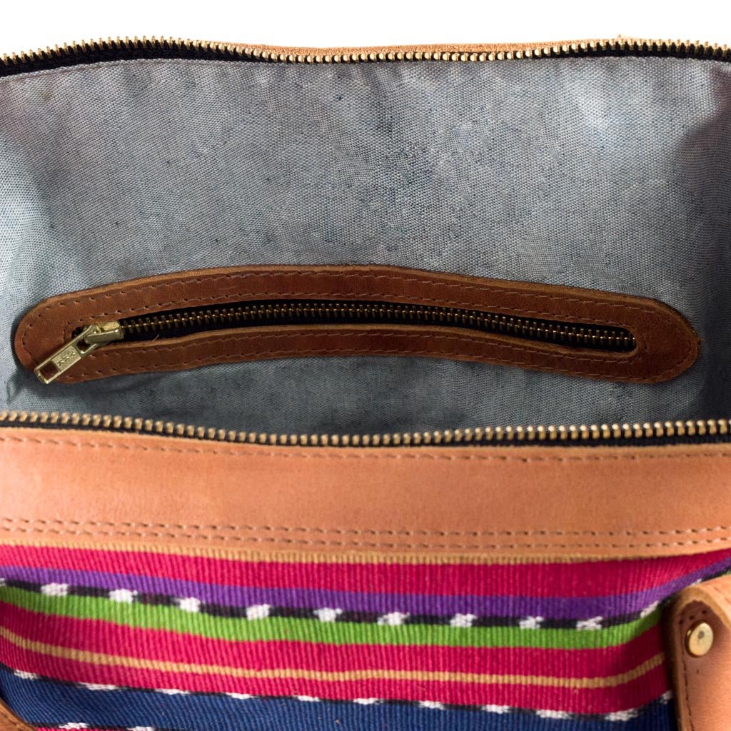 Large Weekender Travel Bag with blue, magenta, green, and jaspe horizontal stripes.  Bag has leather shoulder strap and handles, as well as a front zipper pocket with leather trim.  Under the zipper pocket is a stripe of randa embroidery.