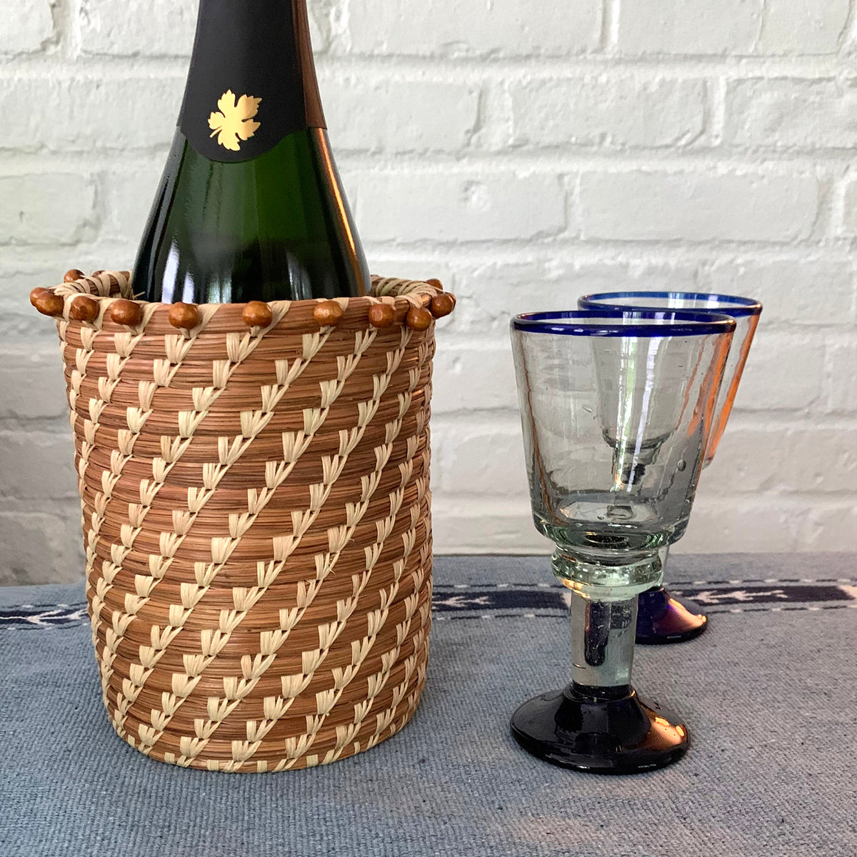 pine needle basket holding wine bottle