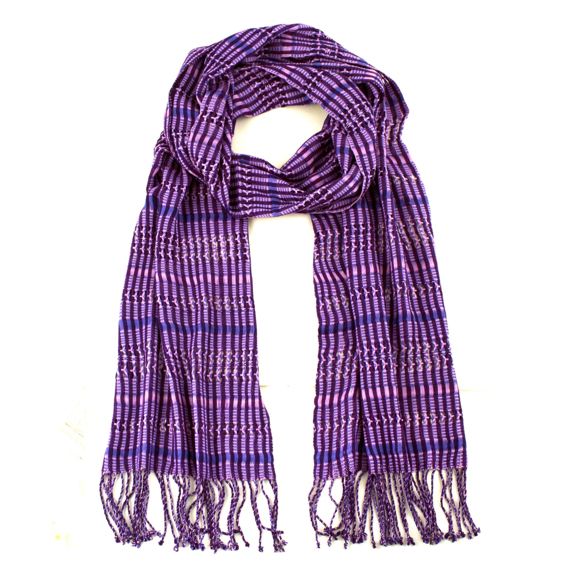 Linda Scarf in Violet, woven from rayon threads in purple and navy tones, with twisted fringe. The scarf is laid flat, wrapped with a circle on white background.