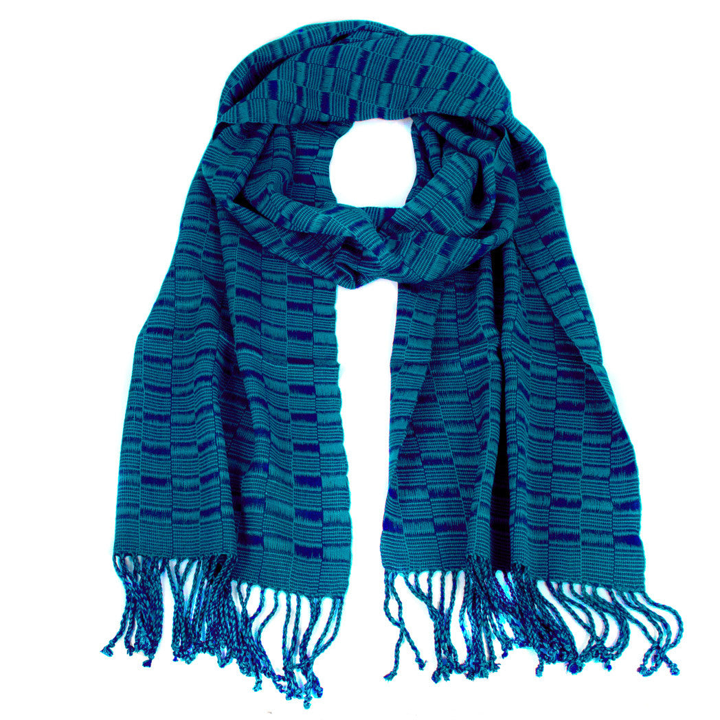 Elsa Scarf in Slate Blue &amp; Teal, made from rayon threads in blue and teal tones, with twisted fringe. The scarf is laid flat, wrapped with a circle on white background..