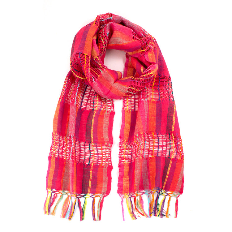 Lattice Weave Scarf in Pink, made from multicolor cotton thread with pink overtones, with fringe. The scarf is laid flat, wrapped with a circle on white background.