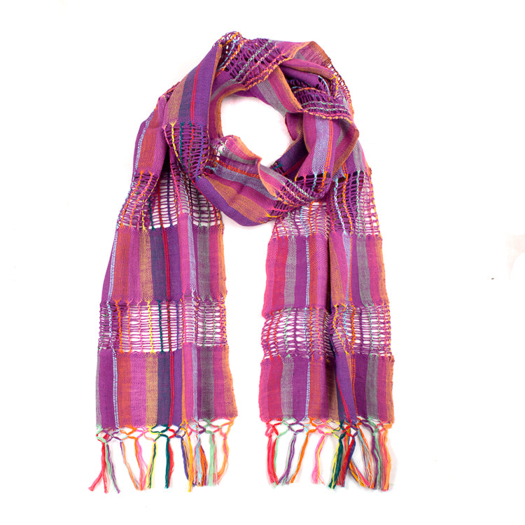 Lattice Weave Scarf in Purple, made from multicolor cotton threads with purple overtones, with fringe. The scarf is laid flat, wrapped with a circle on white background.