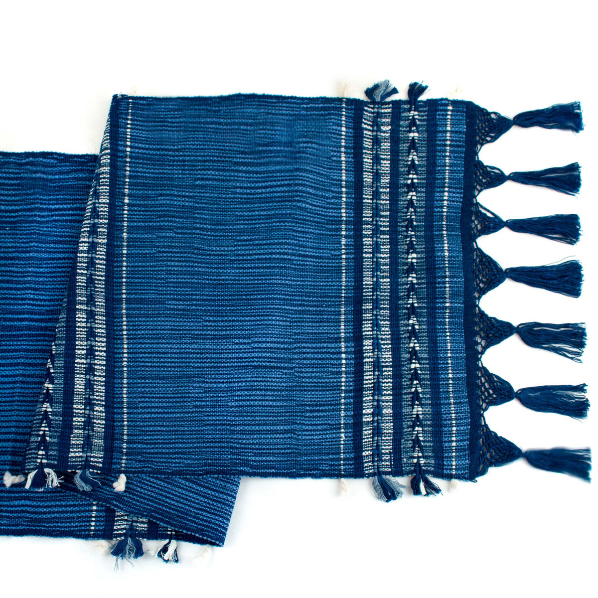 handwoven indigo arrow pattern table runner with twisted fringe