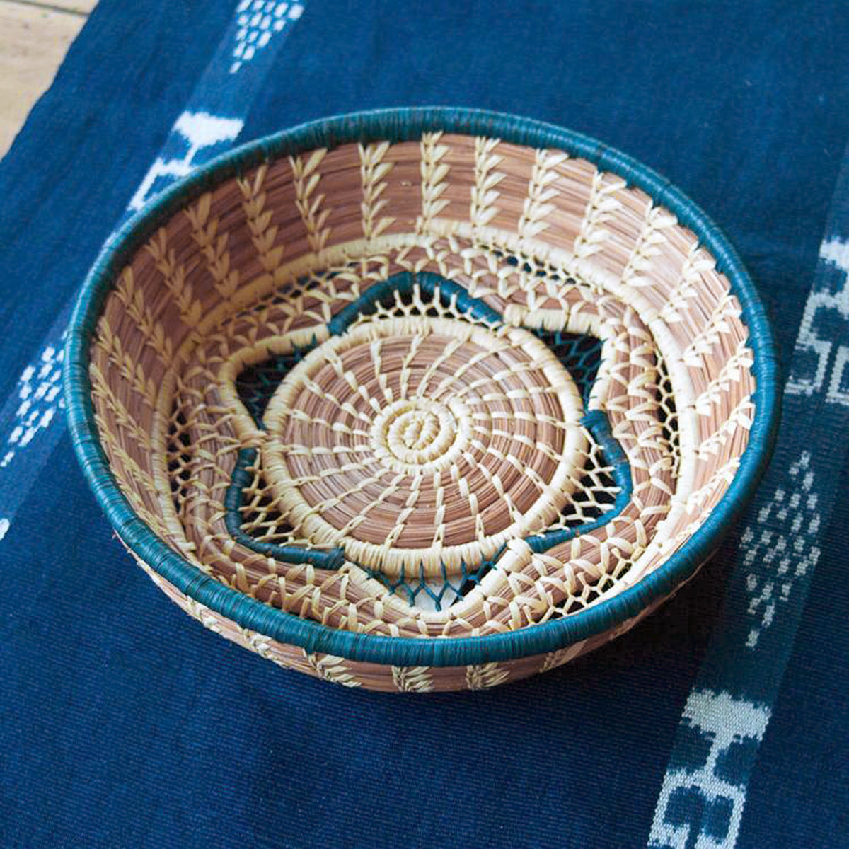 pine needle basket with blue star accent on table runner