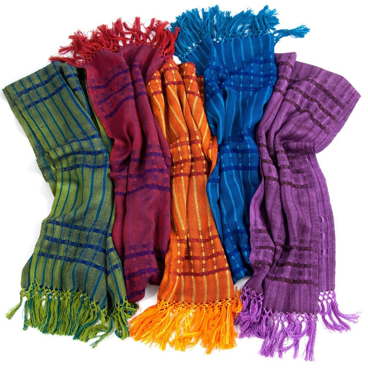 An assortment of Lucia Scarves - from left to right, the Lucia Scarf in green, red, orange, blue, and purple